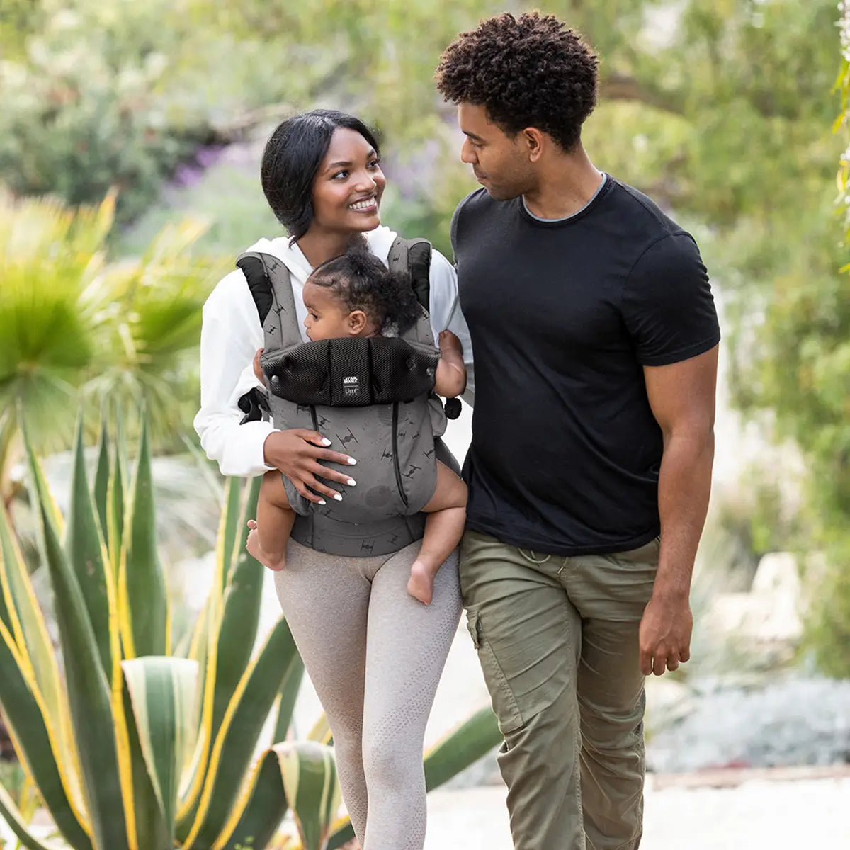 mom wearing baby in Complete 6-in-1 All Seasons in Galactic Icons while walking next to dad