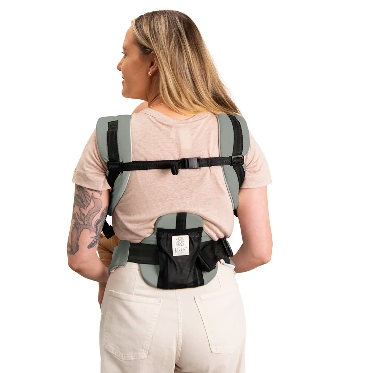 back image of mom wearing baby in elevate air carrier in sea breeze