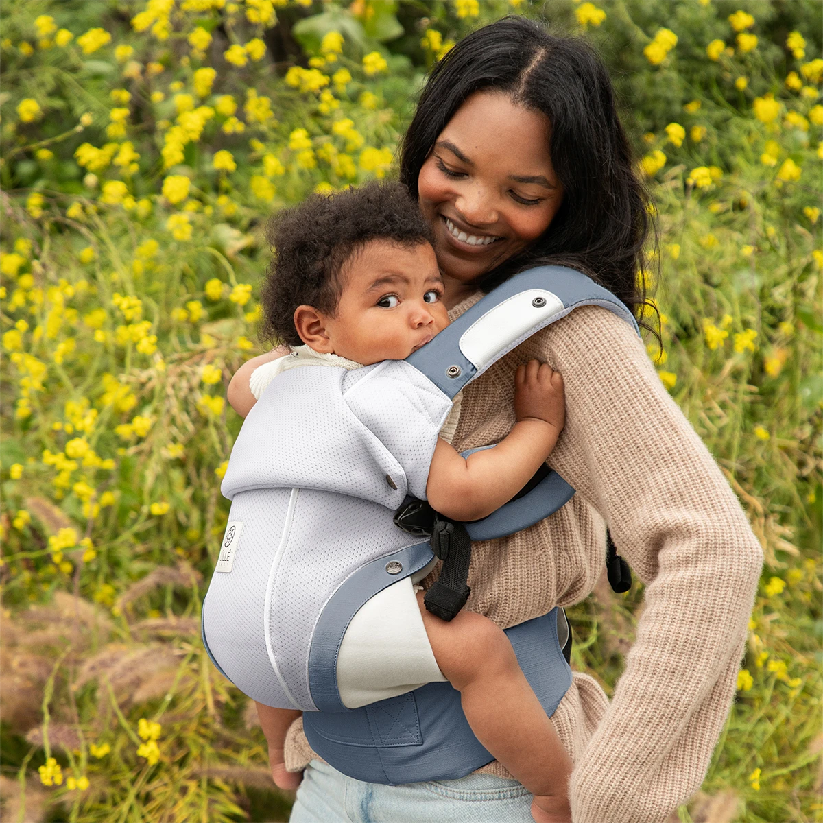 mom wearing baby in elevate air carrier in vapor