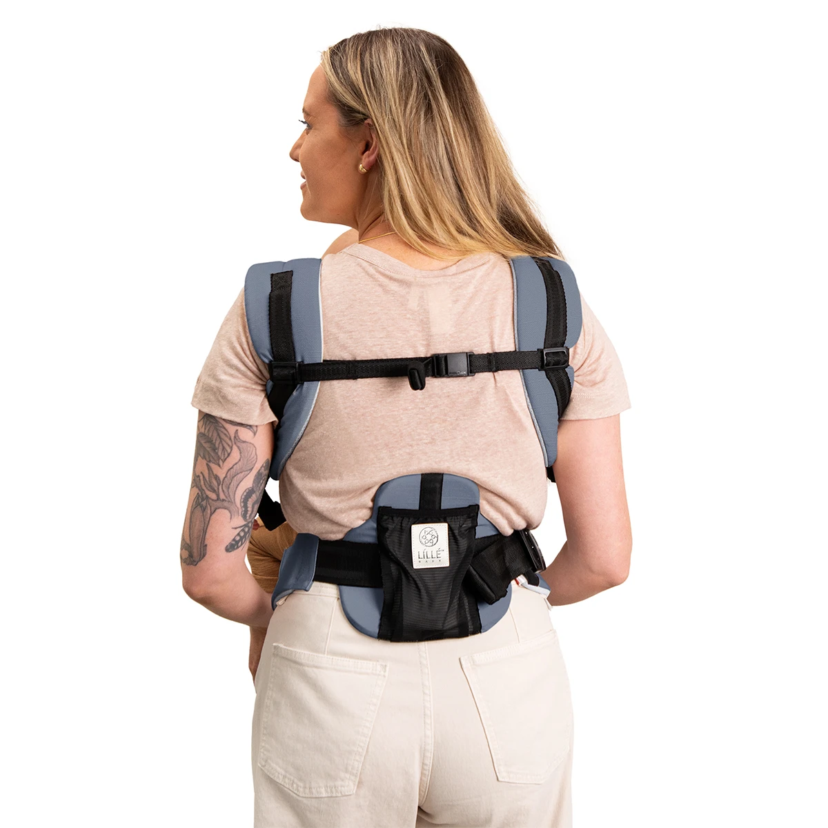 back image of mom wearing baby in elevate air carrier in vapor