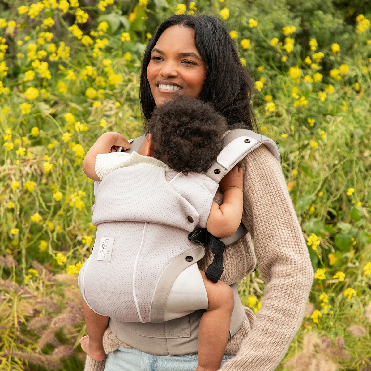 mom wearing baby in elevate air carrier in whisper