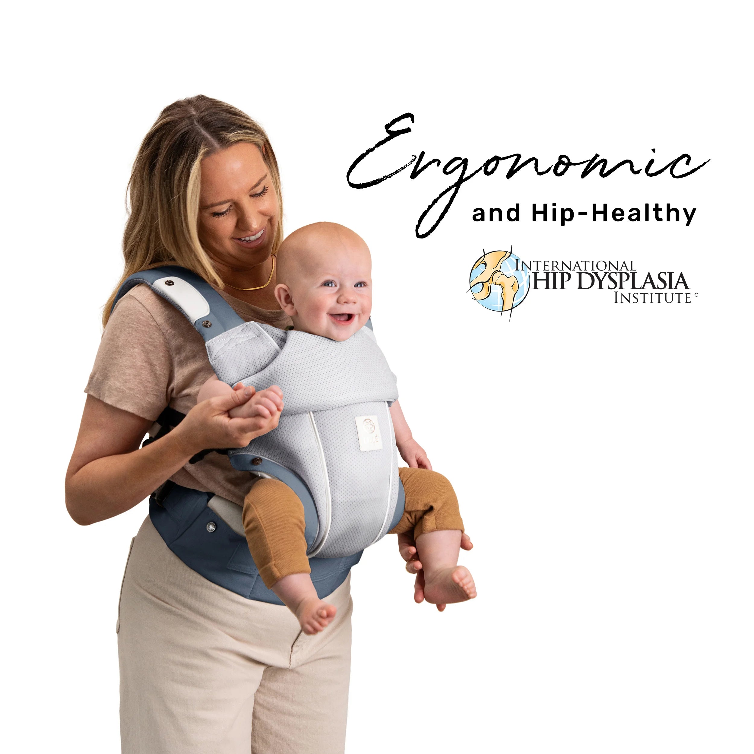 mom wearing baby in elevate air carrier. ergonomic and hip healthy by international hip dysplasia institute.