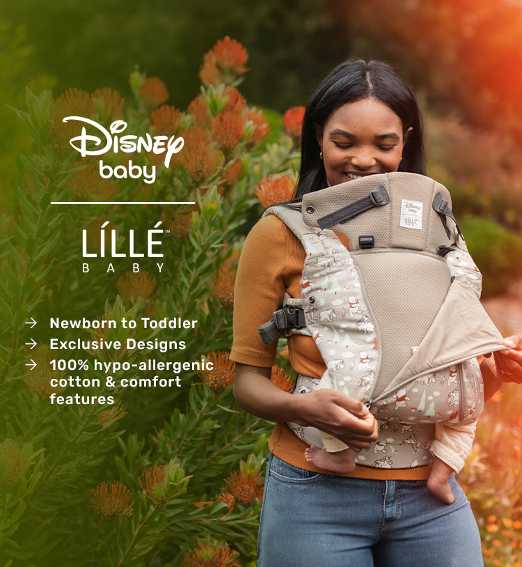 mom wearing baby in lillebaby carrier in pooh's perfect day. lillebaby by disney baby. newborn to toddler. exclusive designs, 100% hypo-allergenic cotton and comfort features