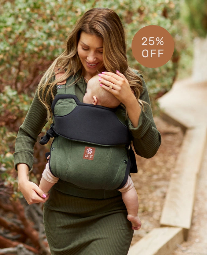 mom wearing baby in elevate carrier in olive 25% off